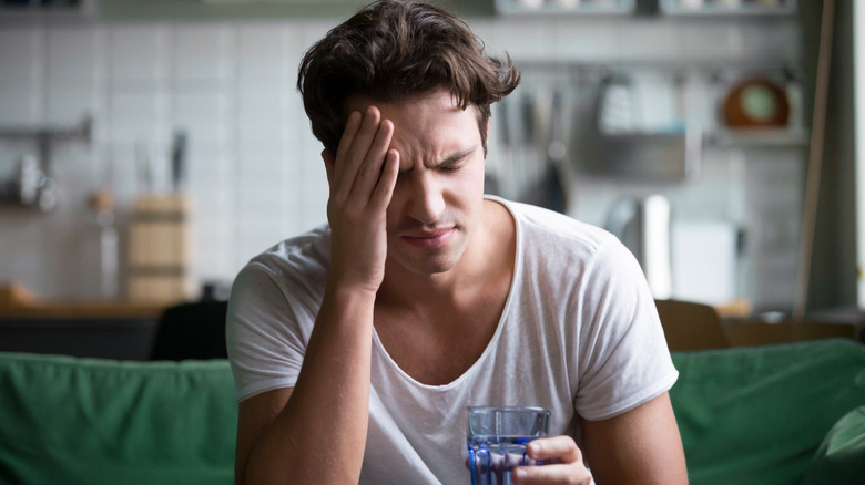 man struggling headache