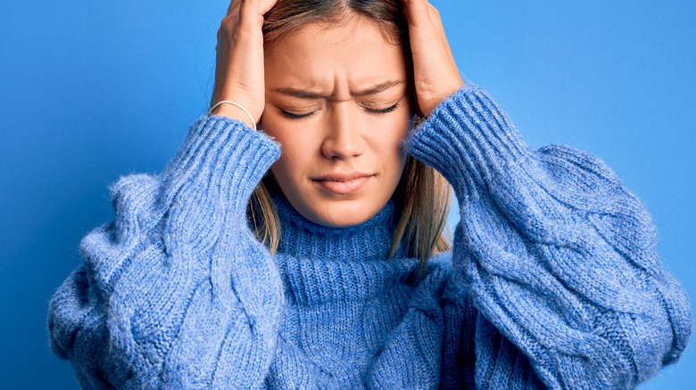 stressed out woman in blue sweater