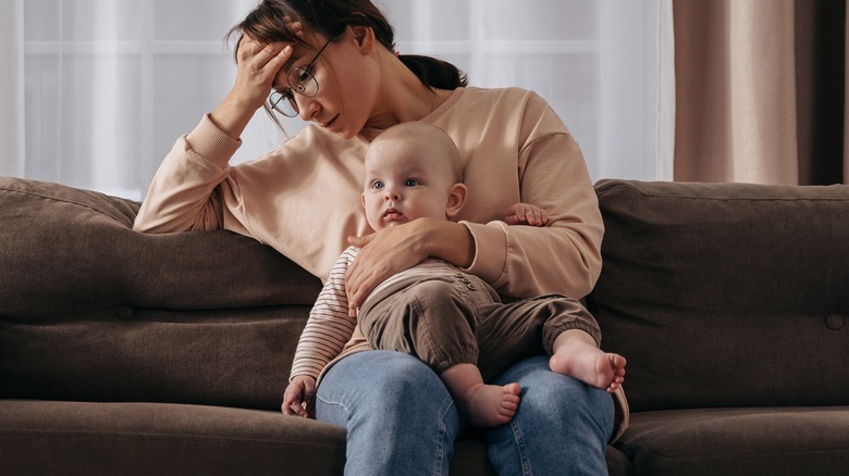 Depressed woman on couch with child