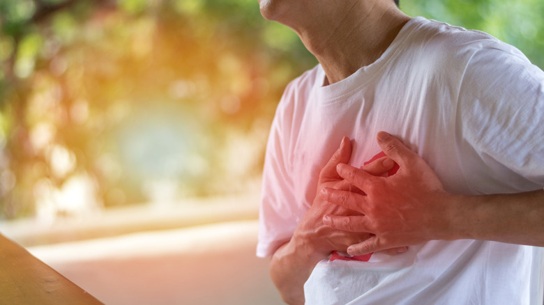 Man having chest pain outdoors