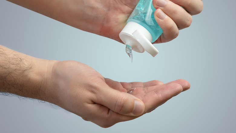 person using hand sanitizer