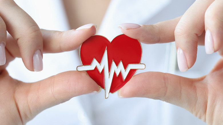 heart pin held by doctor