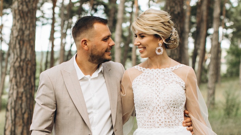 A bride and a groom looking at each other