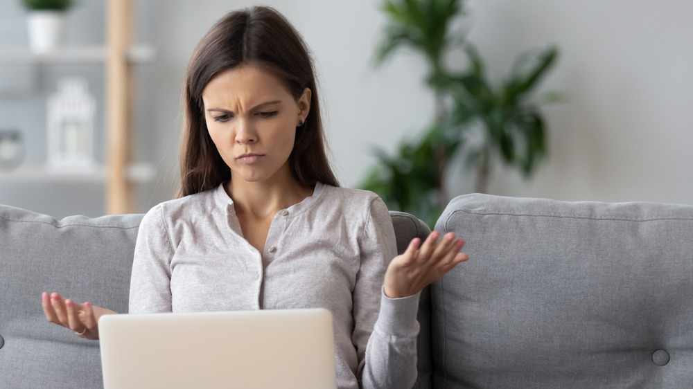 woman on laptop with confused expression on face