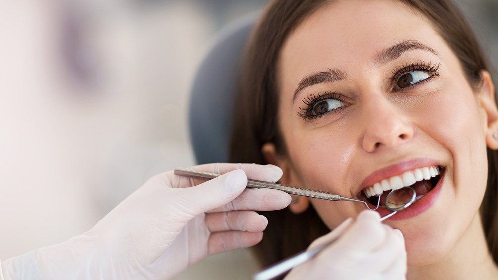 woman having teeth checked at dentist
