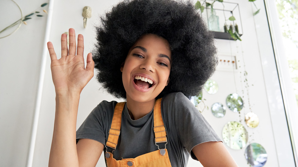 Woman smiling and waving