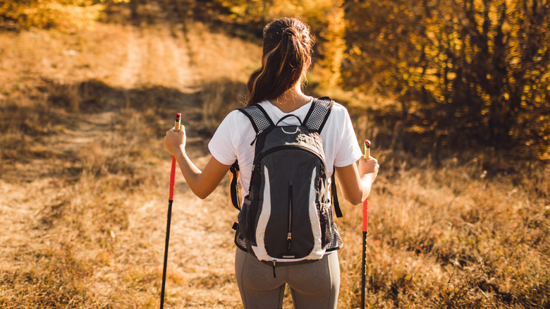 Woman using trekking poles