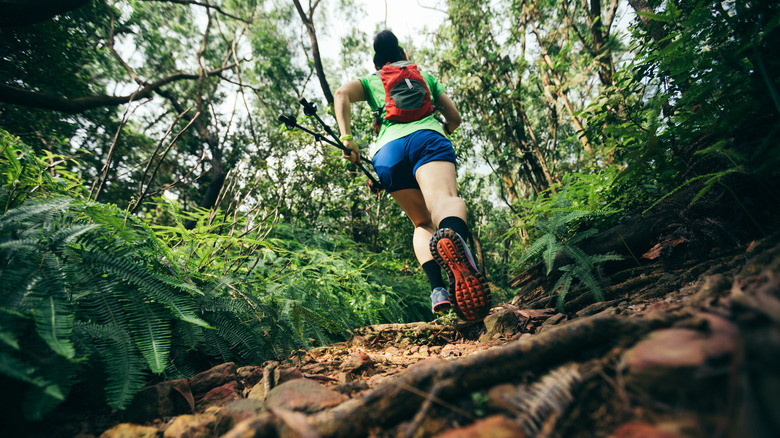 Woman running on tropical trail