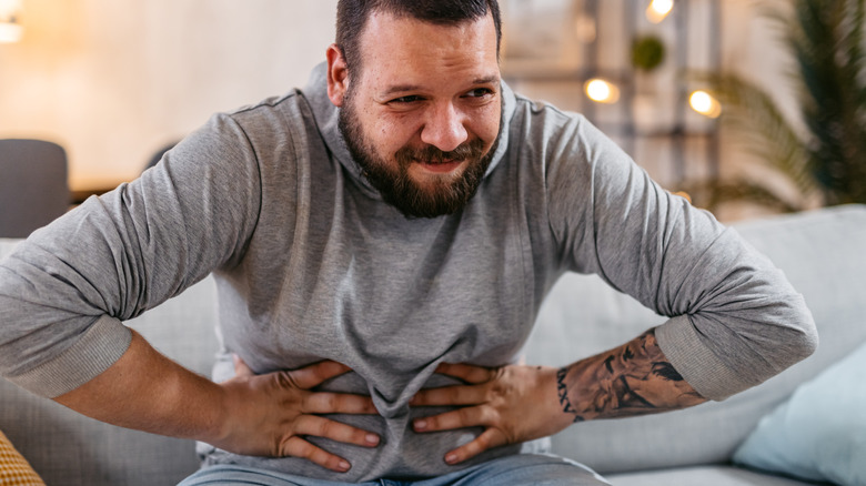 Constipated man holding his stomach
