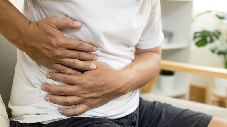 Man holding side with appendix pain