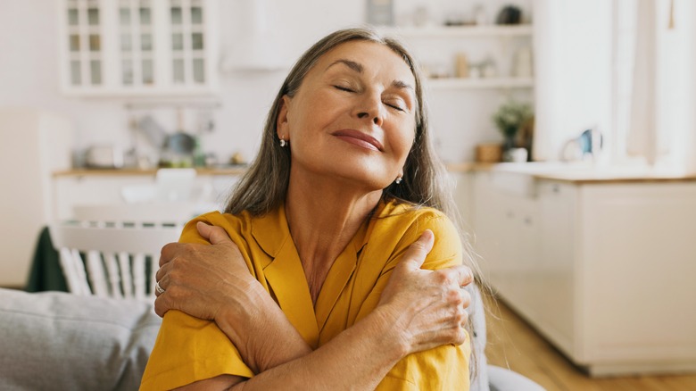 smiling older woman lying in bed