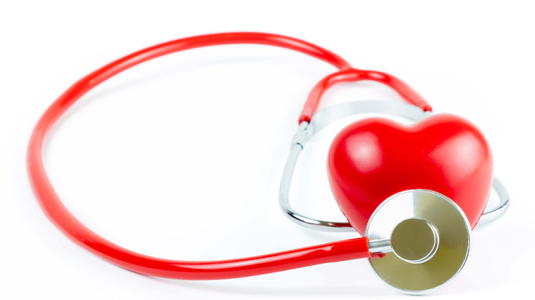 Heart with stethoscope on white
