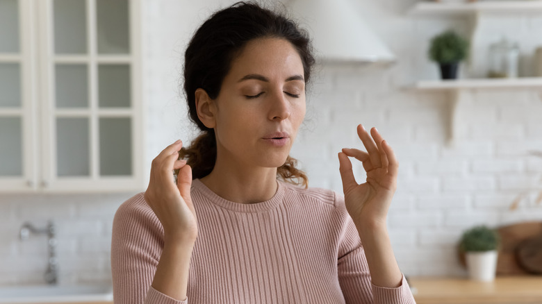 Woman practicing calmness at home