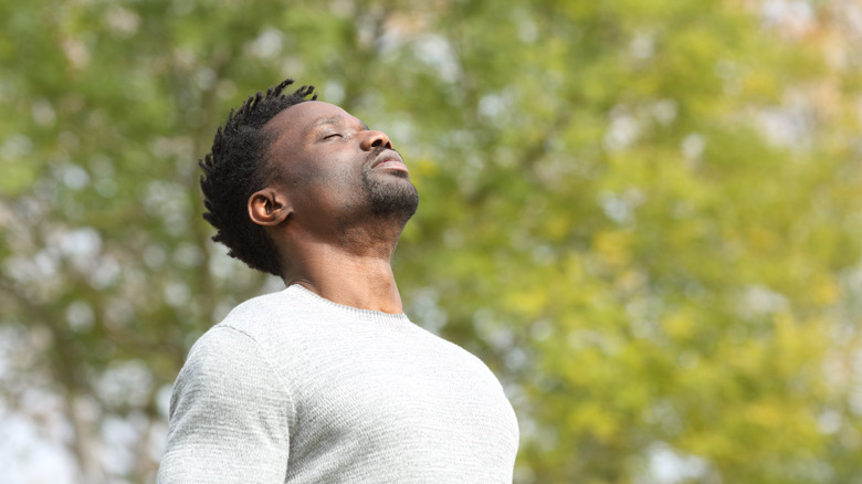 man breathing outdoors