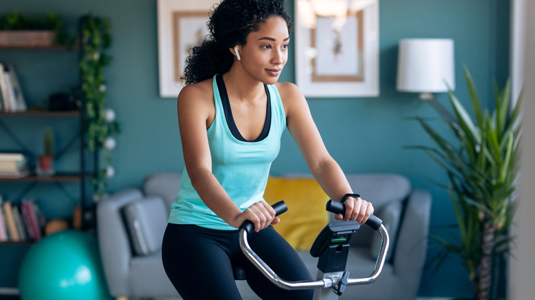 woman exercising on indoor bicycle