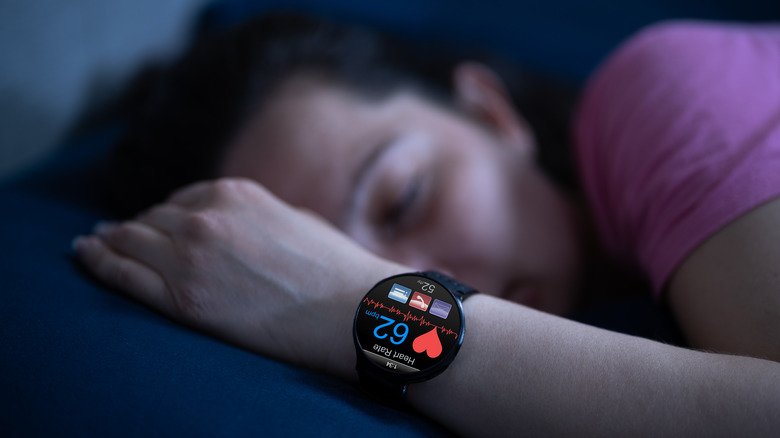 sleeping woman with heart rate watch