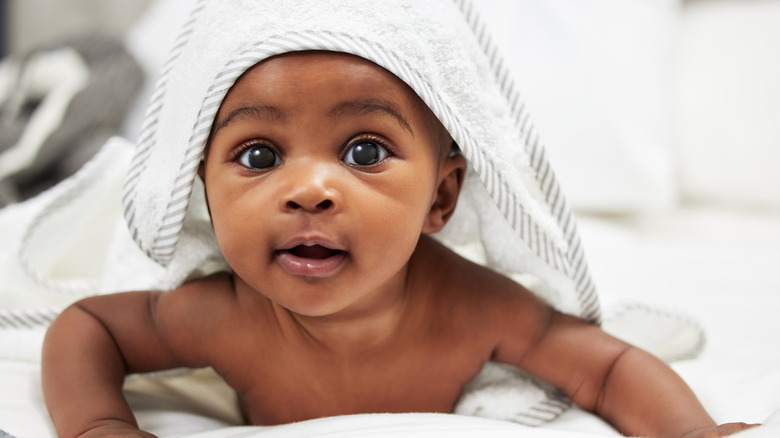 baby boy with blanket over his head