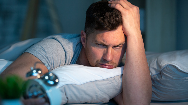 man on bed suffering from insomnia 