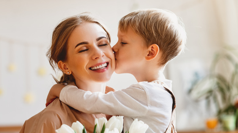 happy mother and son in well-lit room