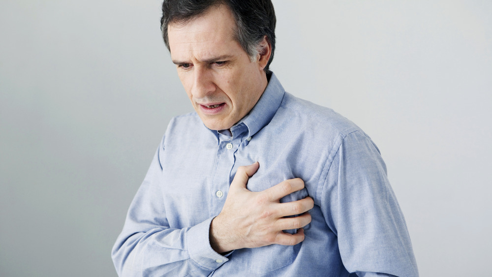 man holding chest