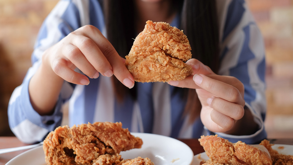 woman holding fried chicken