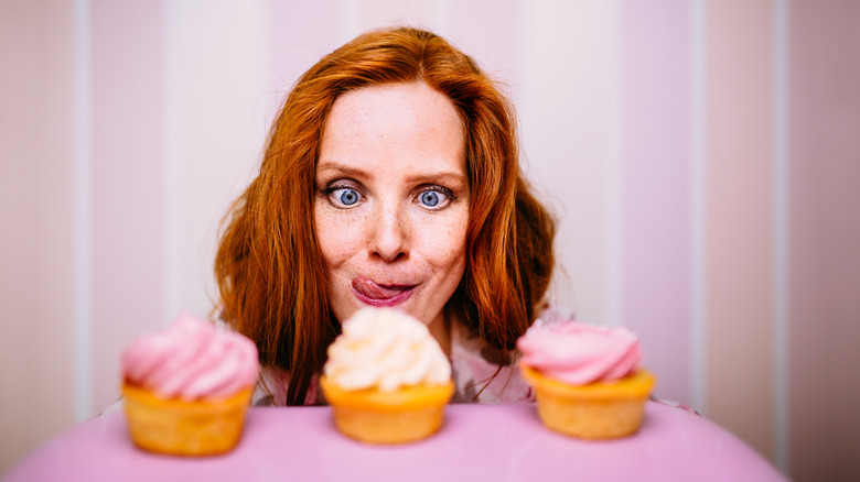 Woman looking at cupcakes
