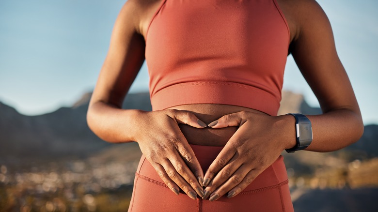 woman with hands on stomach