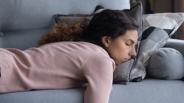 woman lying on couch exhausted