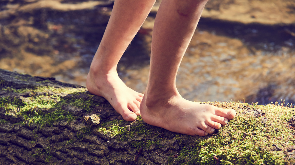 Walking barefoot on a log