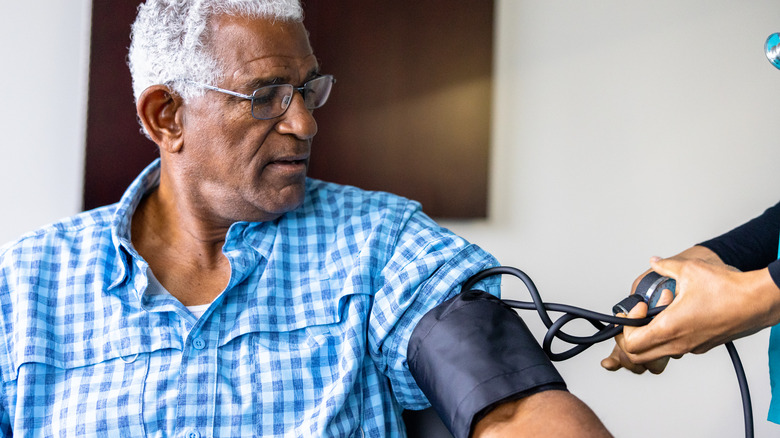 Nurse checking patient's blood pressure