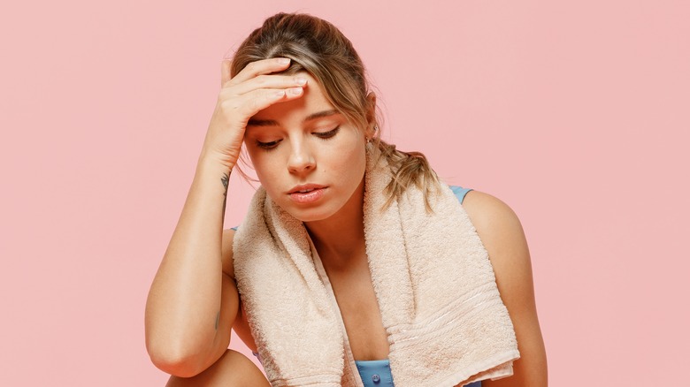 Woman sitting on the ground tired after exercising