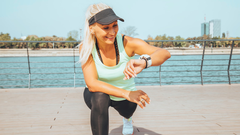 woman looking at smartwatch