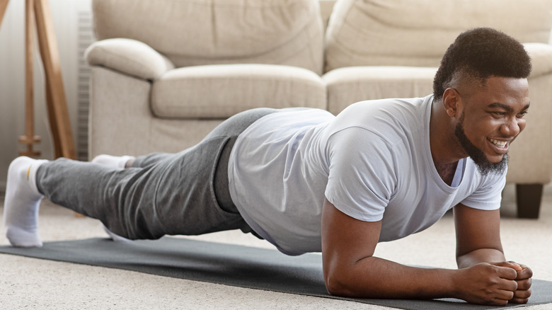 Happy healthy man planking