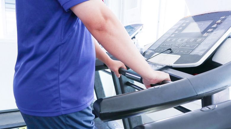 person holding treadmill bars