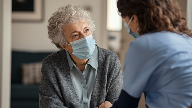 elderly woman and doctor wearing mask