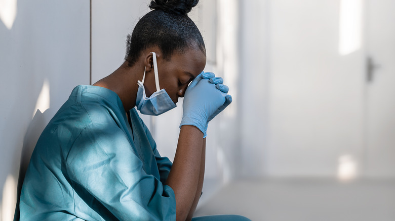 Woman crouching with face mask