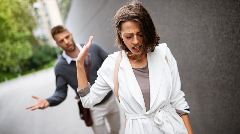 angry upset woman walking away from man