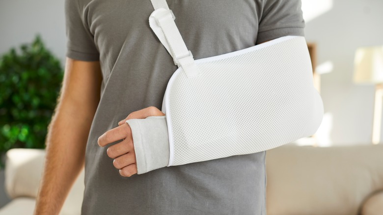 closeup of injured man's arm in sling