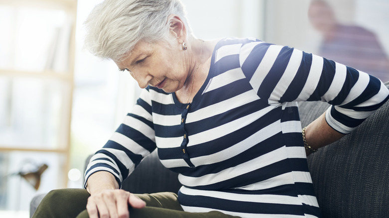 Older woman holding lower back