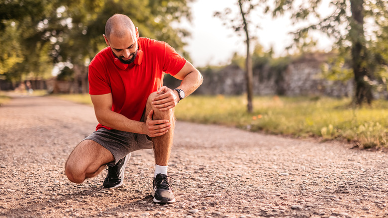 Athlete rubbing knee