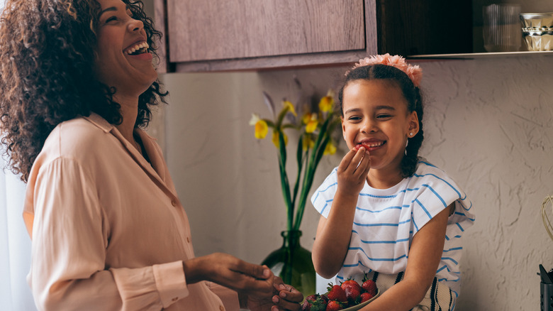 woman and daughter enjoying fruit