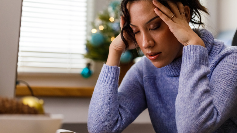 Stressed out woman holding head