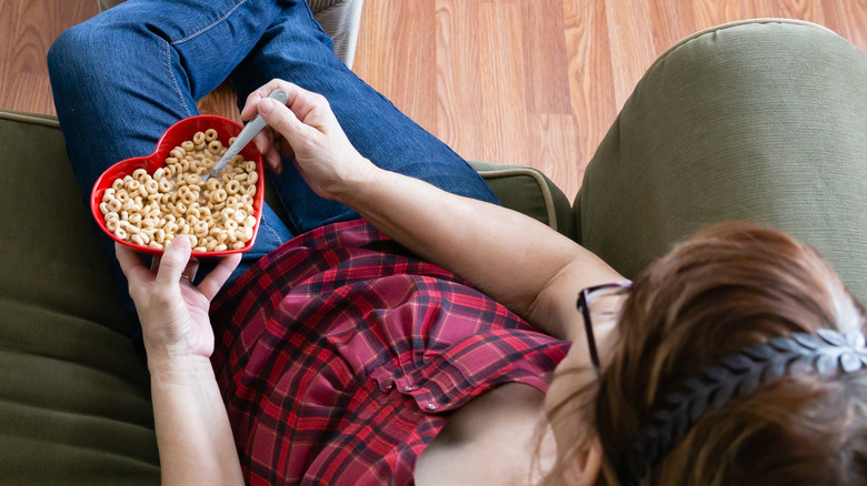 woman eating cheerios in heart-shaped bowl