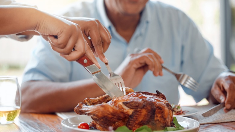 smiling man ready to eat chicken and vegetables