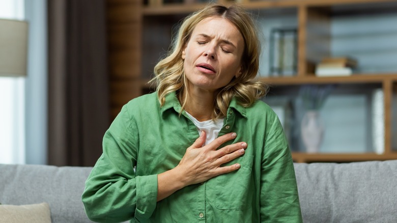 Woman in pain with hand on chest