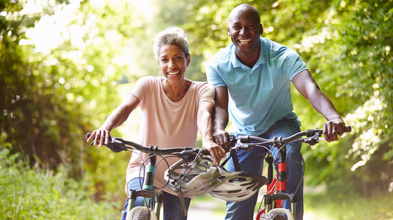 Smiling couple cycling