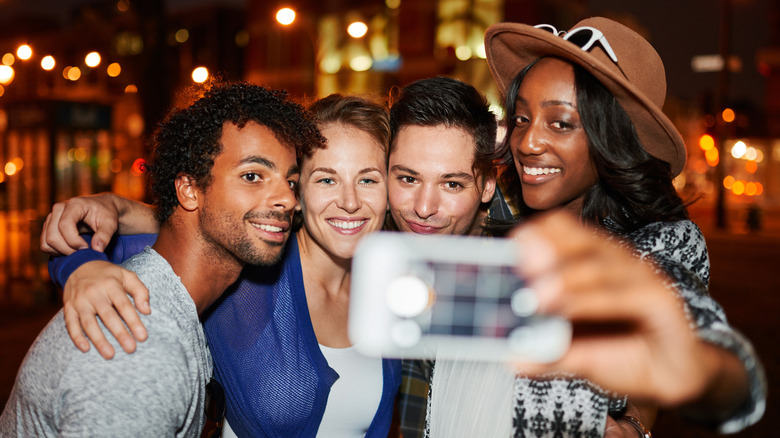 Smiling friends taking selfie