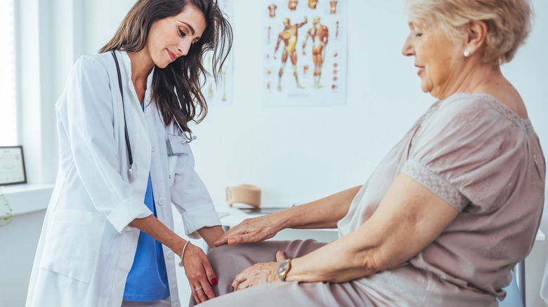 doctor examining patient's knee