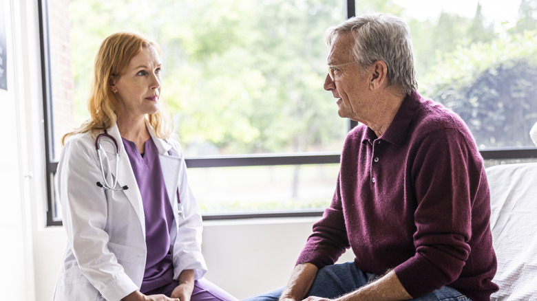 An older man talking to his doctor