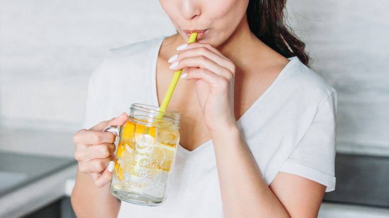 woman sipping lemon water